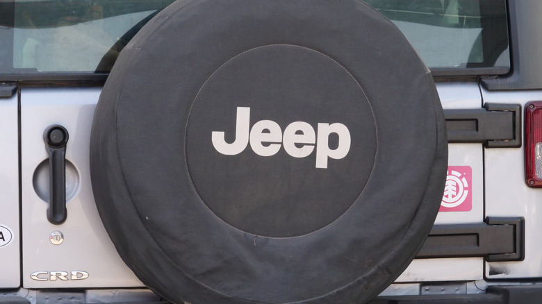 A covered spare tire on a Jeep