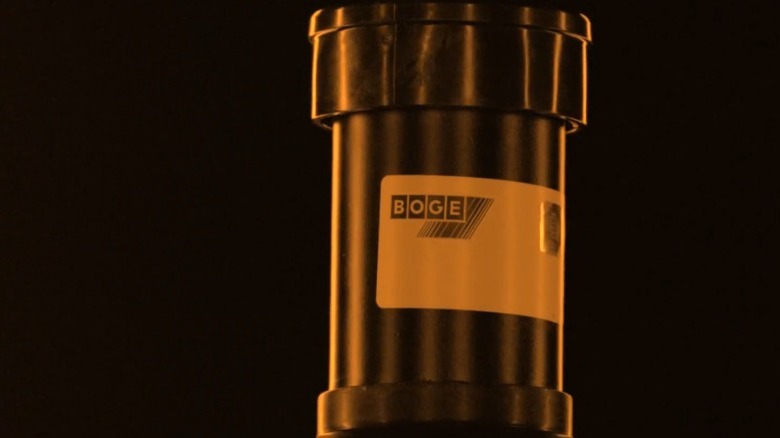 Boge logo on a shock absorber in orange lighting