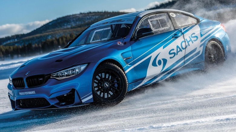 Blue BMW with Sachs livery drifting in snow