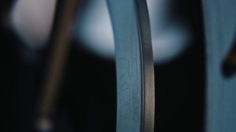 Shallow focus image of TRW logo on a motorcycle brake disc