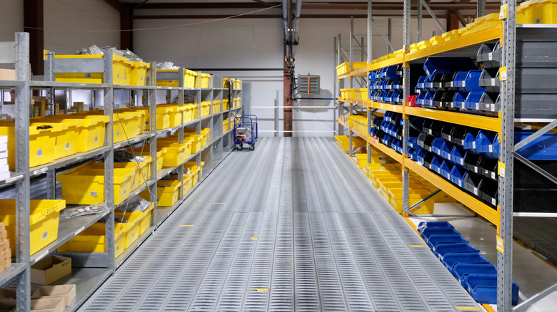 A warehouse stocked with auto parts in bins and shelves.