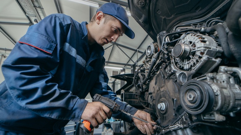 Close-up of mechanic working on vehicle