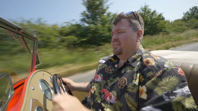 Jay Emm driving an MG down a country lane