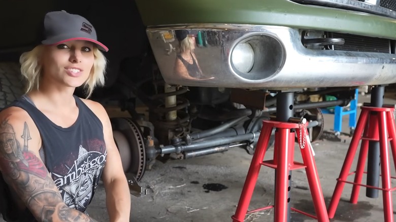 The Diesel Queen mechanic sitting next to Dodge truck for repair