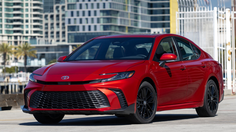 Front 3/4 view of Toyota Camry in urban seaside setting