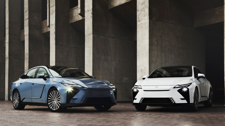 Front 3/4 views of Lexus ES EV and Lexus ES hybrid in architectural setting