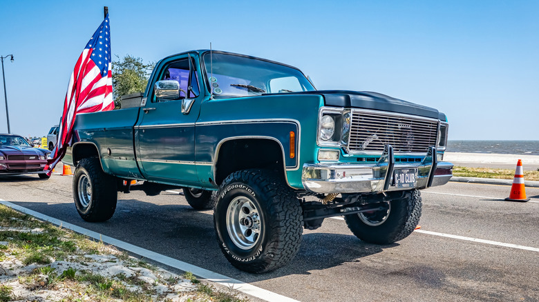 Chevy Square Body truck with American flag at car show