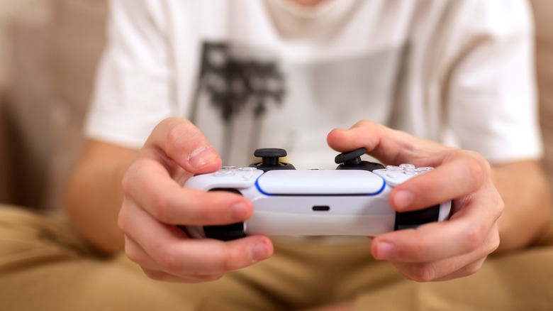 Young person holding PS controller