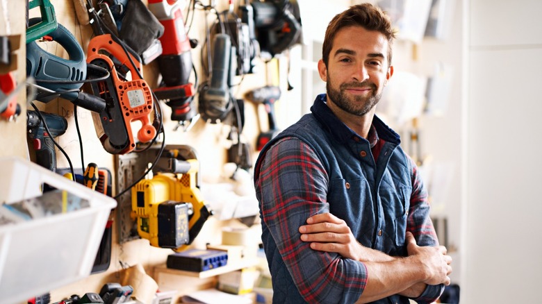 Man standing in front of tools