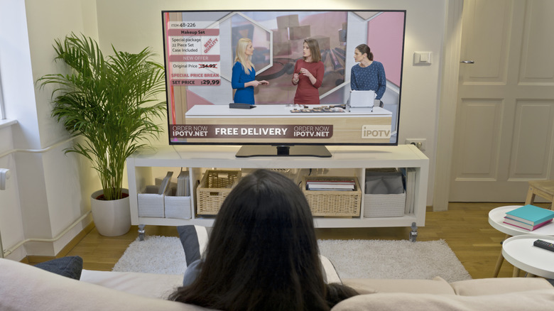 Person watching ads on television