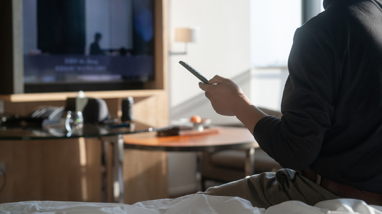 Man watching hotel TV