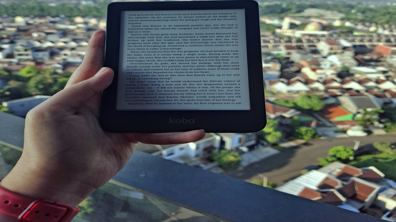 person reading outside with e-book