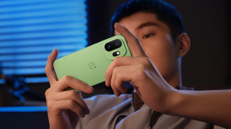 Person holding a OnePlus 15T in landscape mode