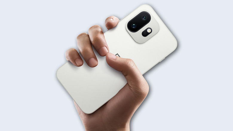 A hand holding the OnePlus 15T