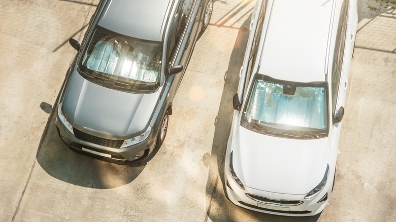 Cars parked in open sun