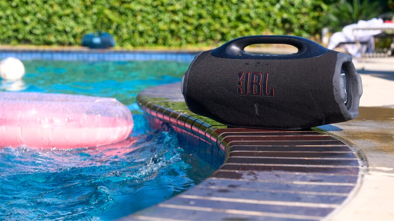 The JBL Boombox 4 sitting next to a pool.