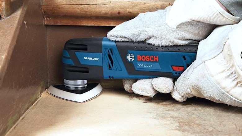 Person using Bosch multitool