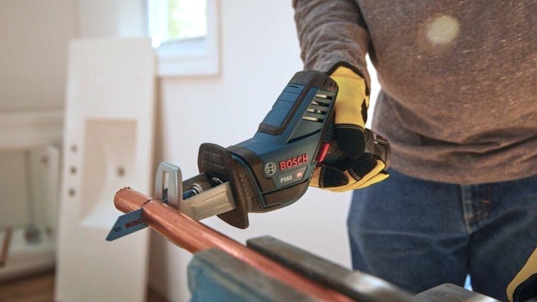 Person using Bosch 12V Max reciprocating saw