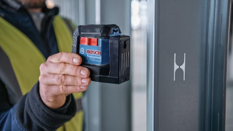 Person holding Bosch 50 ft.Self-Leveling Cross Line Lase