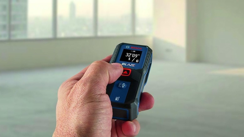 man using laser measure