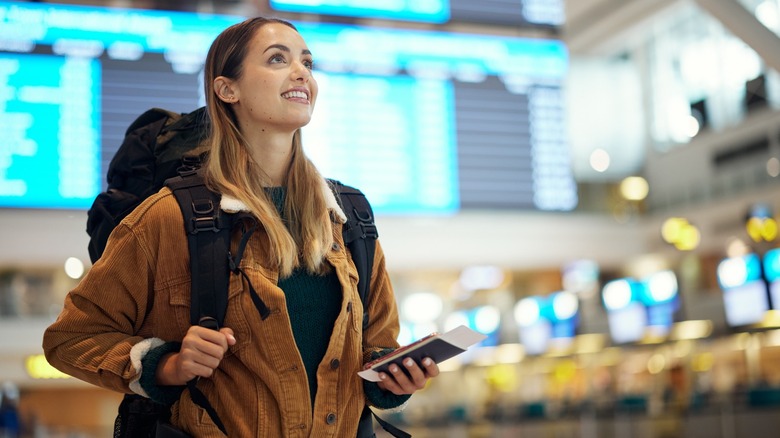 person holding phone at airport