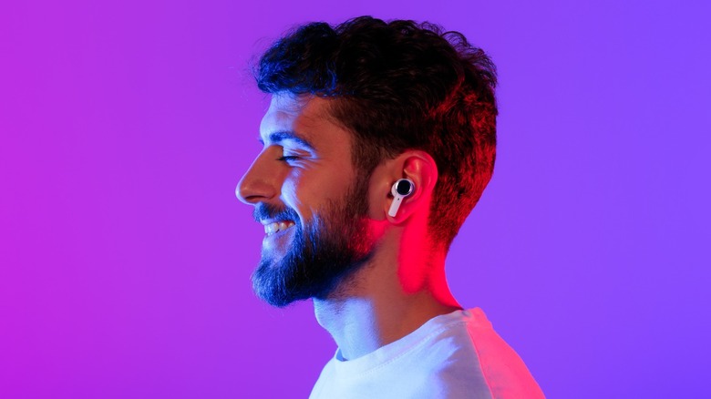 person using wireless earbuds