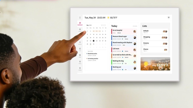 man using wall mounted digital calendar