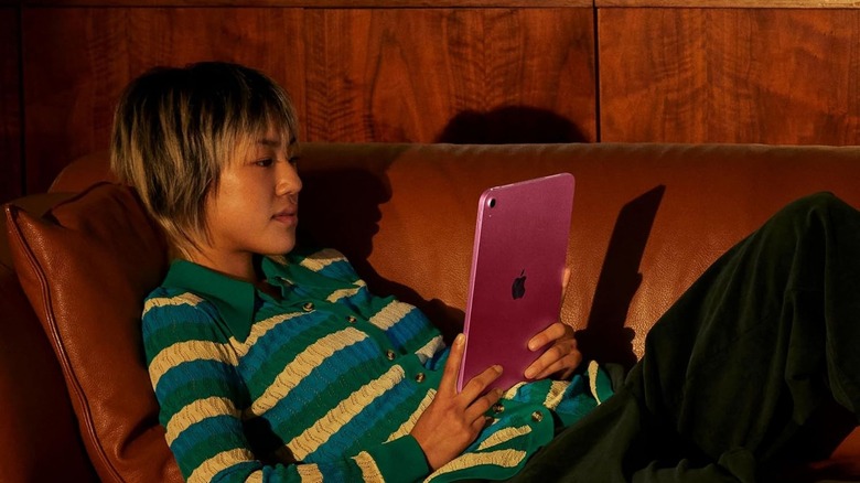 woman using Apple 11-Inch iPad on couch
