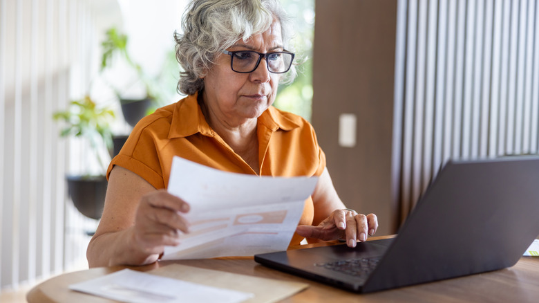 woman paying bills on a laptop