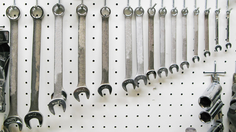 Wrenches hanging on a pegboard