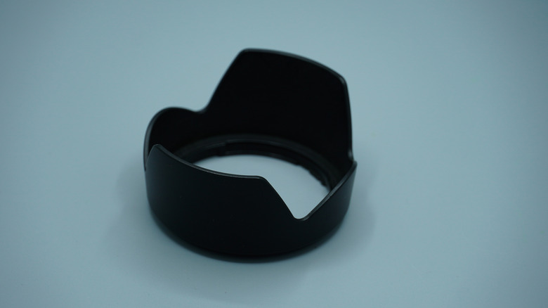 A camera lens hood on top of a table