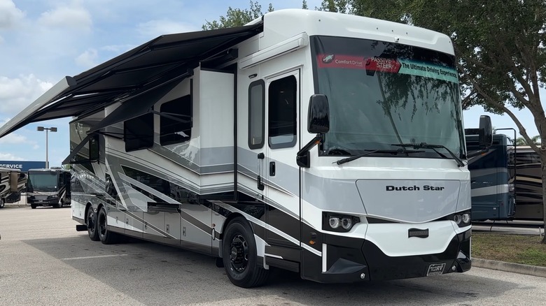 2027 Newmar Dutch Star with awnings and walls extended, front-right 3/4 view