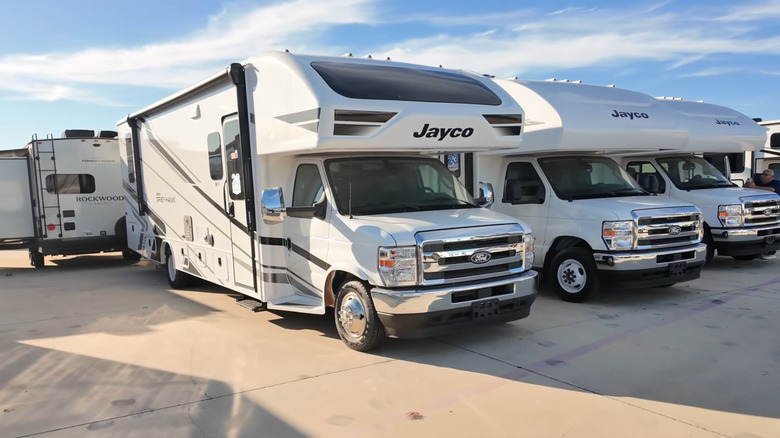 A trio of Jayco Greyhawk Ford chassis on a parking lot, front-right 3/4 view