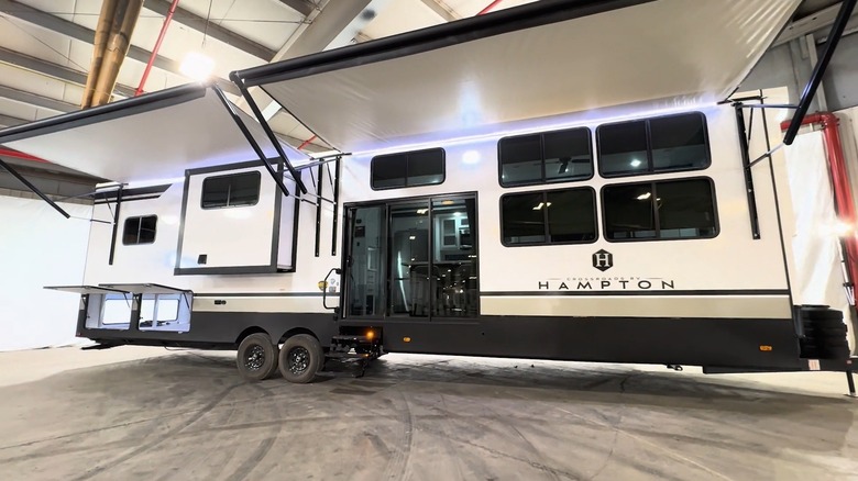 Crossroads Hampton RV with awnings extended, right-side view