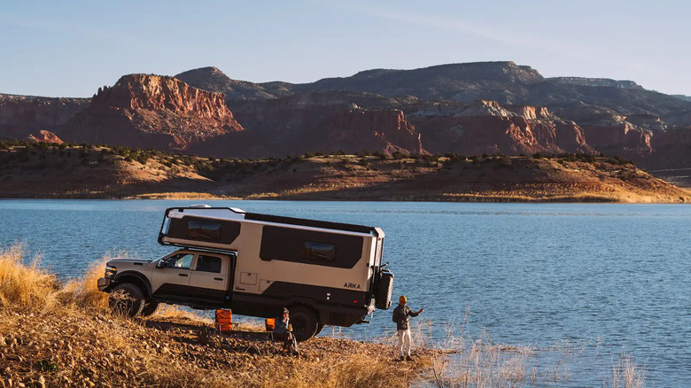 Winnebago ARKA parked lakeside with man fishing, left-side view