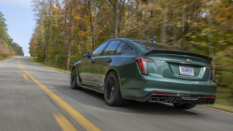 Rear view of green Cadillac CT5-V Blackwing on country road.