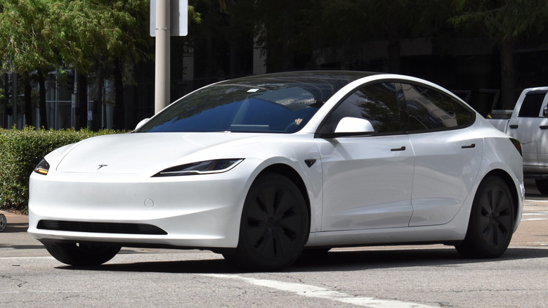 White Tesla driving