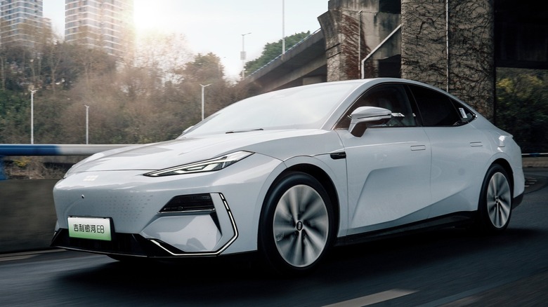 Geely Yinhe E8 EV driving on road going under freeway bridge