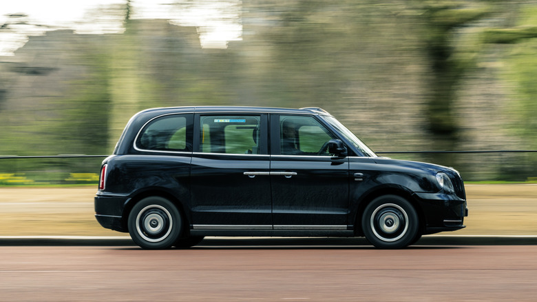 LEVC TX Black Cab traveling on road, right-side view