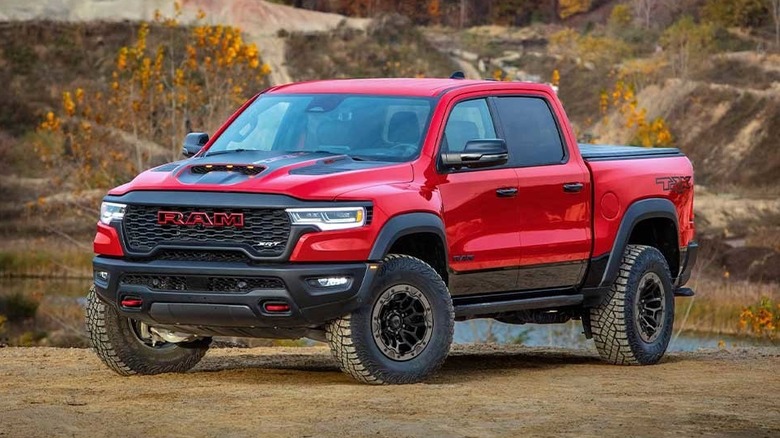 A red Ram TRX truck parked in a rural environment.