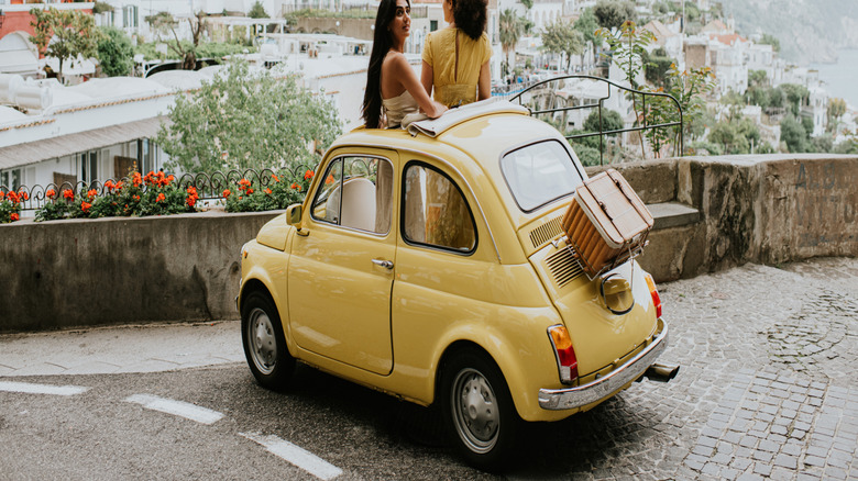 yellow fiat on clifftop