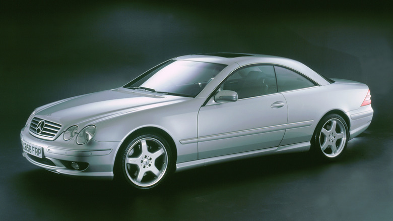 Front 3/4 view of silver Mercedes CL55 AMG parked in studio.