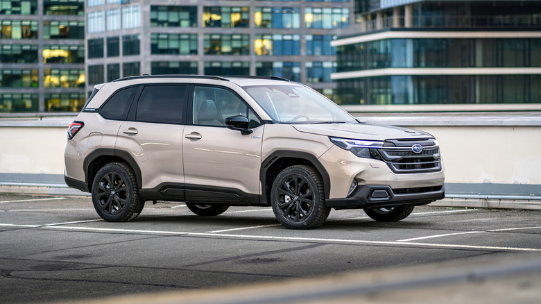 A 2025 Subaru Forester parked on the side of a road, cityscape