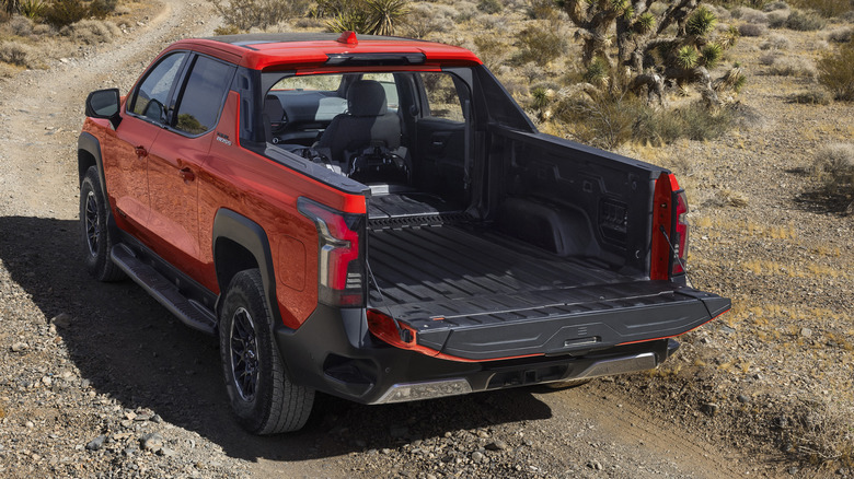 Rear 3/4 view of Chevy Silverado EV Trail Boss with lowered midgate.