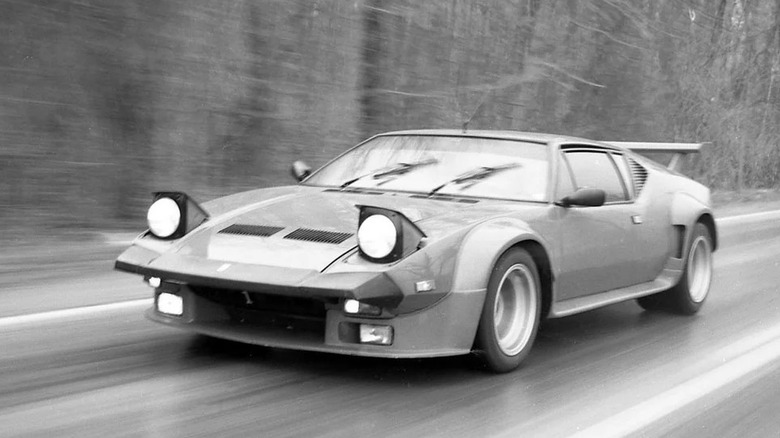 De Tomaso Pantera driving at speed on country road, front-left view, black & white picture
