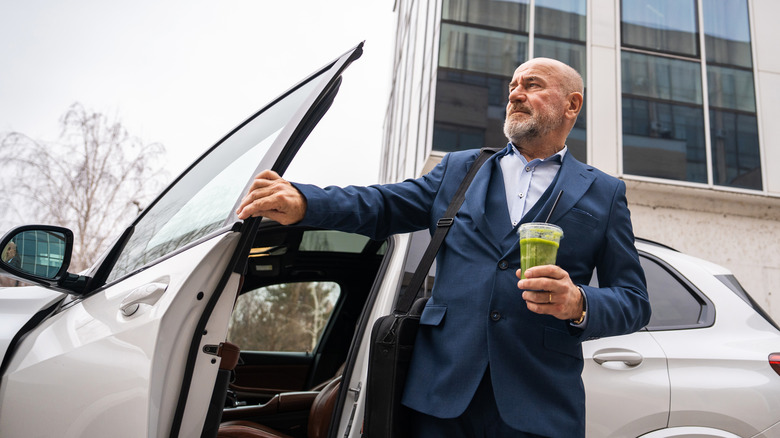 A man getting out of his car and closing the door