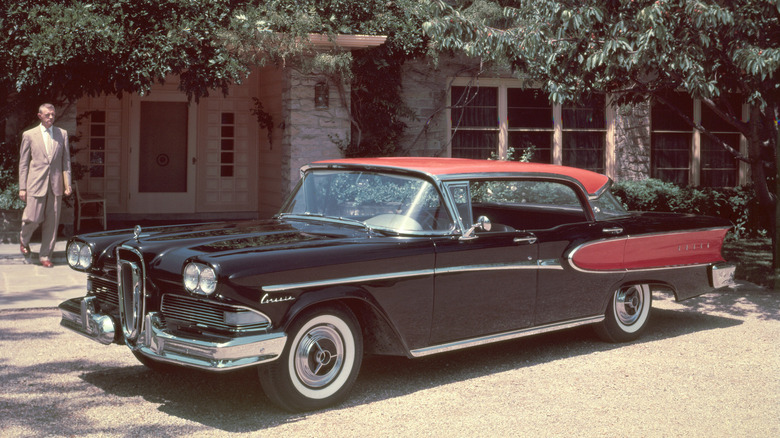 A 1958 Edsel Corsair Four Door hardtop sedan standing in a suburban driveway, finished in black and red.