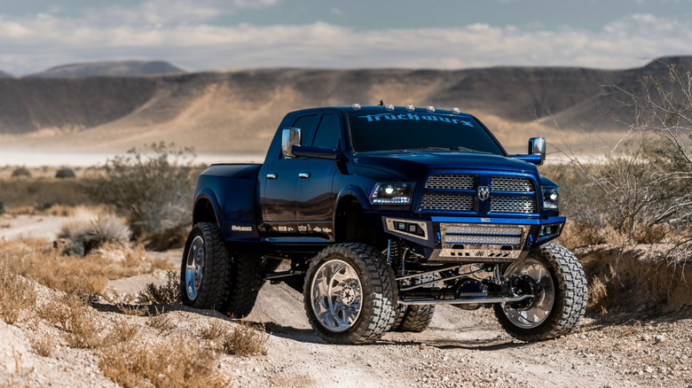 Lifted RAM 3500 on a dirt road front 3/4 view