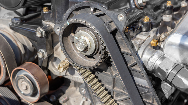 Close-up of timing belt in engine, focusing on crankshaft pulley