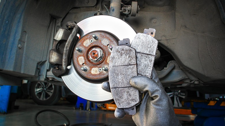 Mechanic holding used brake pads